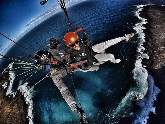 Tandem paragliding passenger enjoying the flight